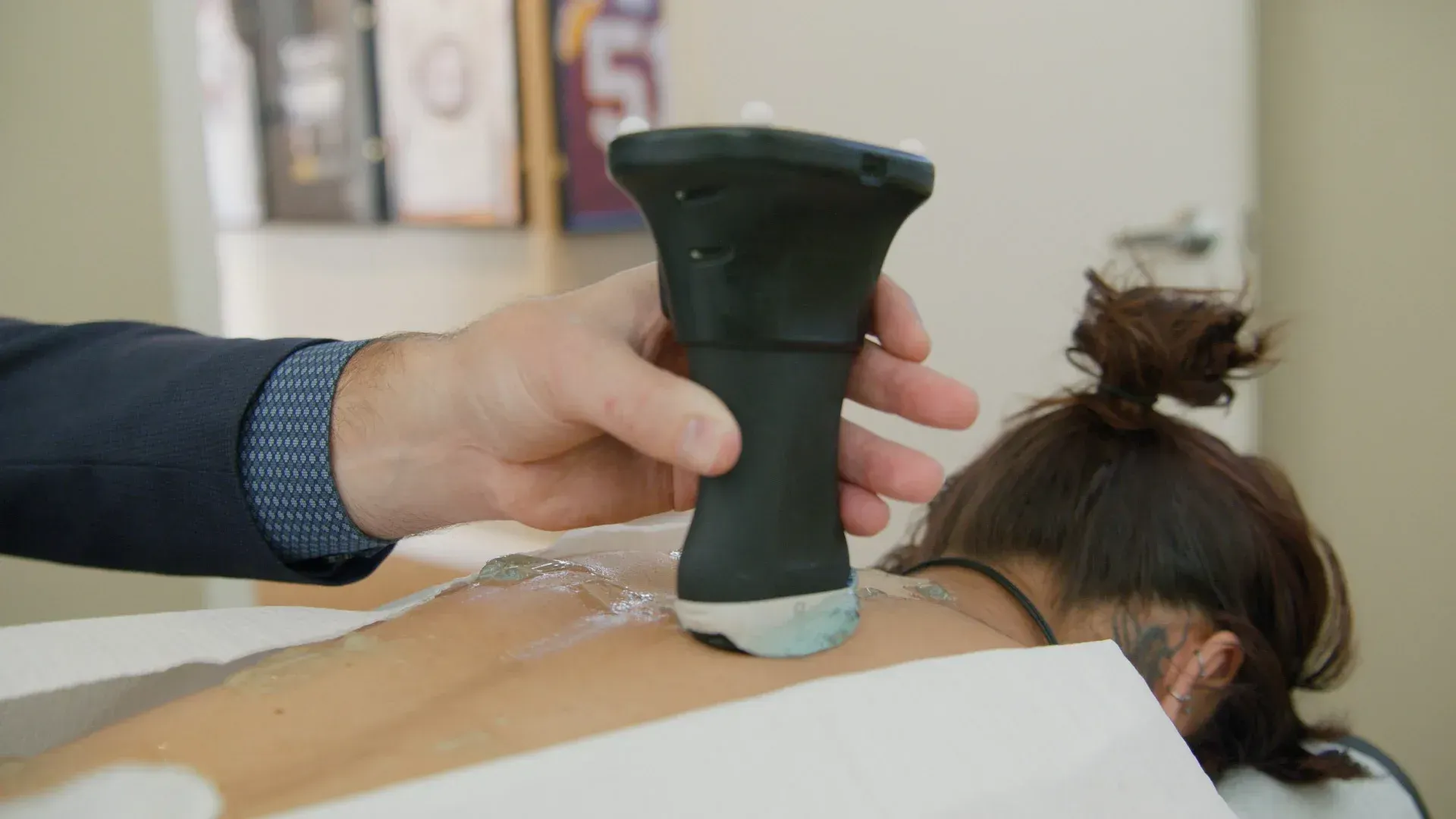Person laying down while a device is placed on their back.